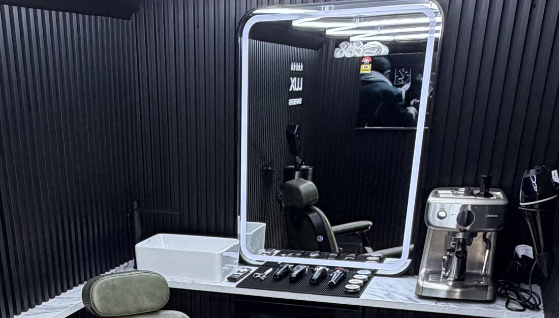 Inside the Lux Barbers mobile studio — LED mirror, marble bench and tools laid out ready