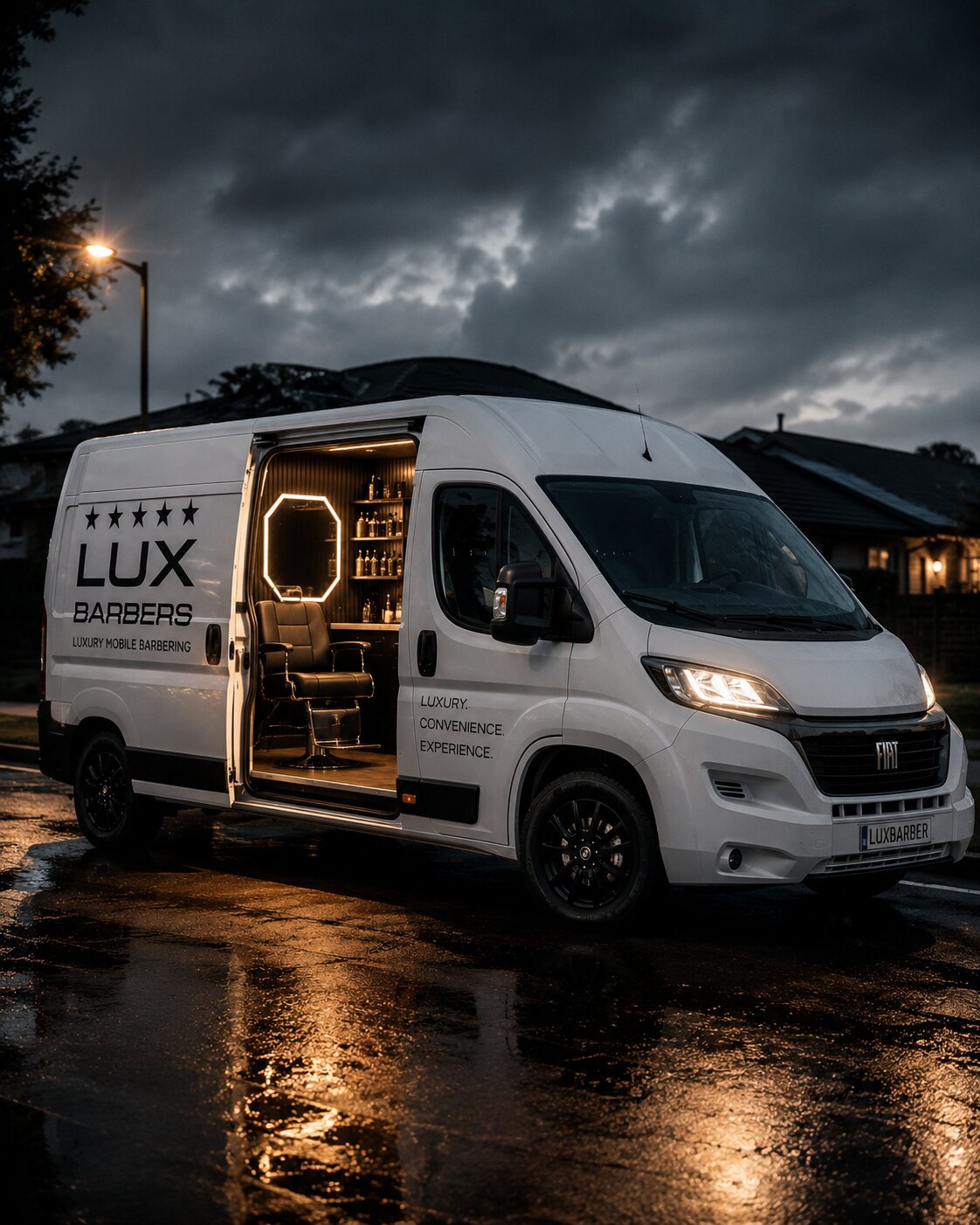 The Lux Barbers van parked outside the Wise Guys barbershop at dusk, side door open with the lit studio inside