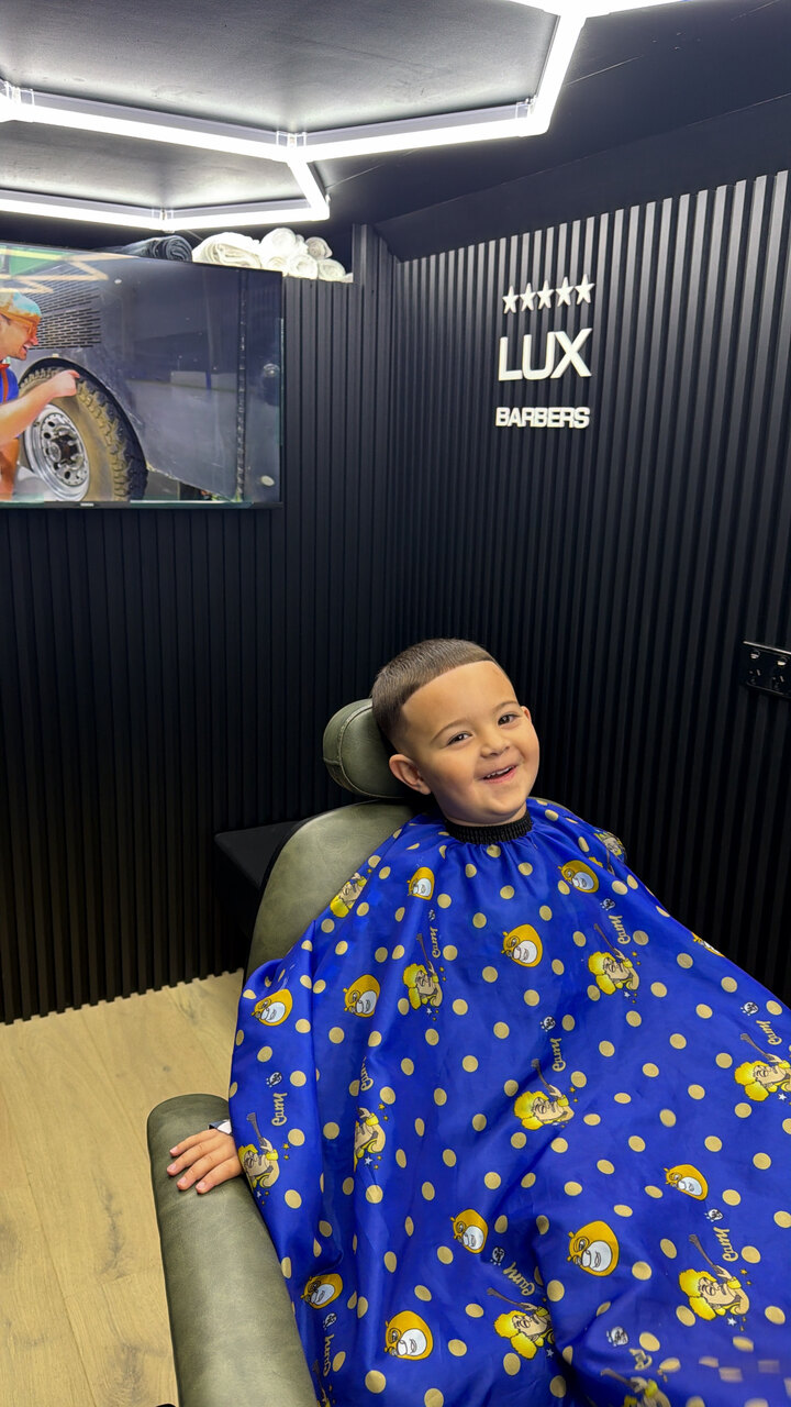 A young client all smiles after his cut in the studio